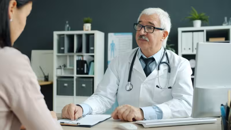 What Does Ear Wax Removal in Oxford Cost?: A doctor in a clinic Doctor in clinic for What Does Ear Wax Removal in Oxford Cost? - Travel Time To Hearing First Oxford
