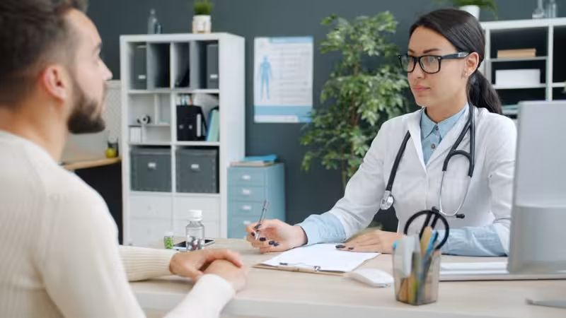Parking and Arrival at the Clinic: A doctor and patient during a consultation Doctor and patient consultation for Parking and Arrival at the Clinic - Travel Time To Hearing First Oxford